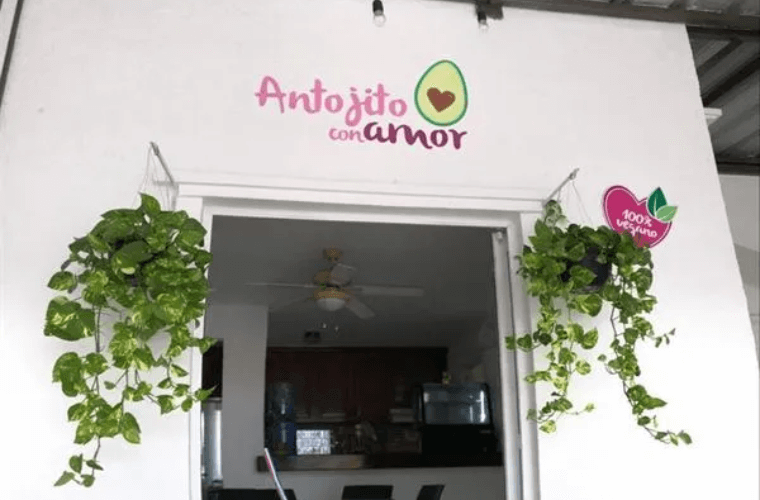 the entrance to Antojito Con Amor with the name above the doorway 