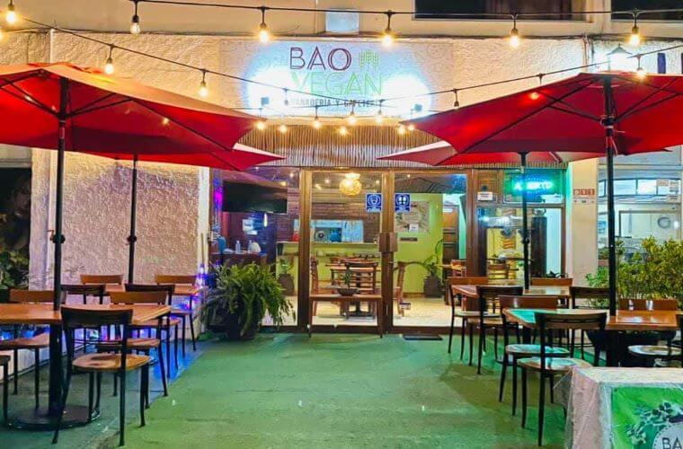 exterior seating area at Bao Vegan with the name above the entrance 