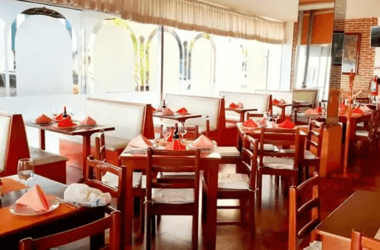 chairs and tables in the interior of Taste of India 