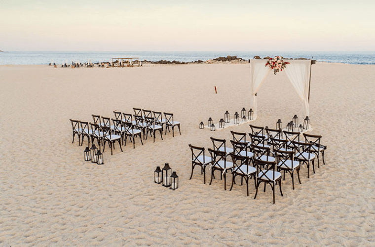 wedding setup at Paradisus Cancun with a decorated wedding arch and chairs for the guests 