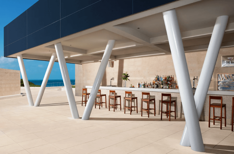 bar with stools lined up for people to sit