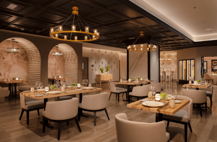 the interior of Coquette restaurant with chairs and tables set for dinner 