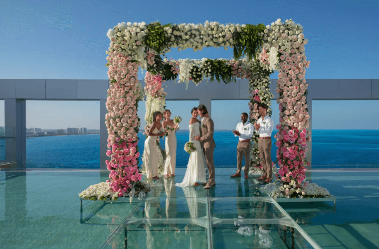 a rooftop wedding with the bride and groom plus two male and two female attendants 