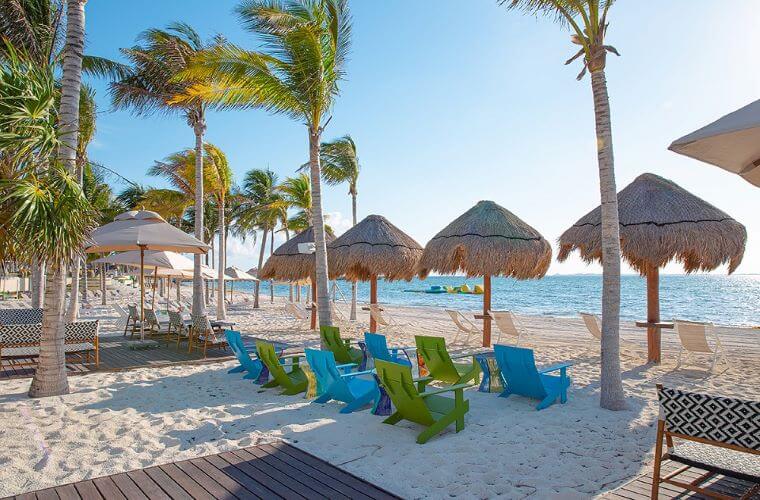 palm trees and beach loungers on the beach at Garza Blanca Cancun 