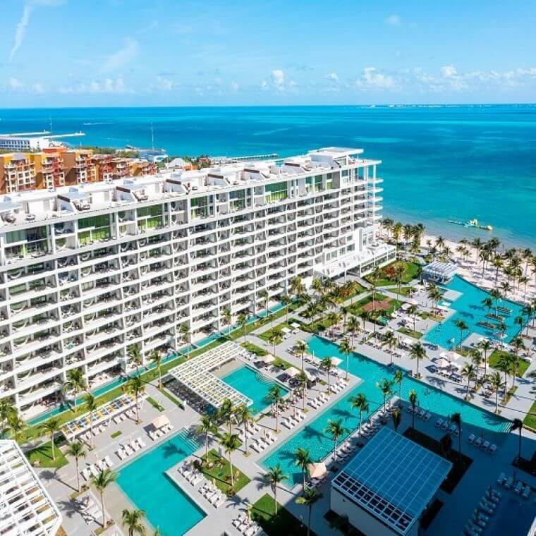 the pool area at Garza Blanca Cancun with the accommodation in the background 