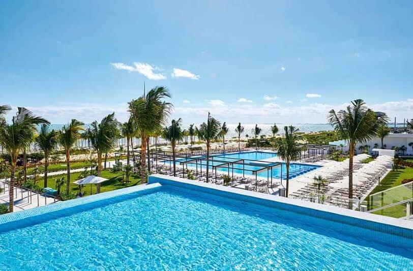 swimming pools and palm trees at Riu Palace Costa Mujeres