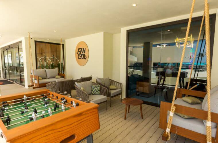 Cancool family room at Royal Uno Cancun with games and a seating area 