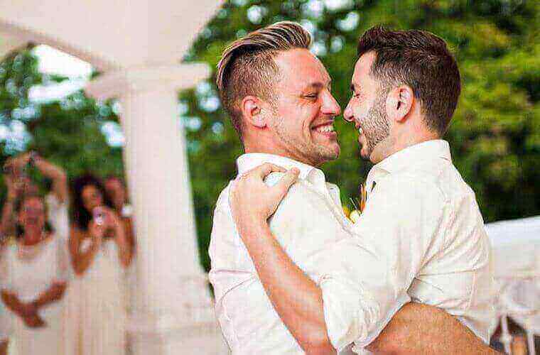 an all male couple dancing together 