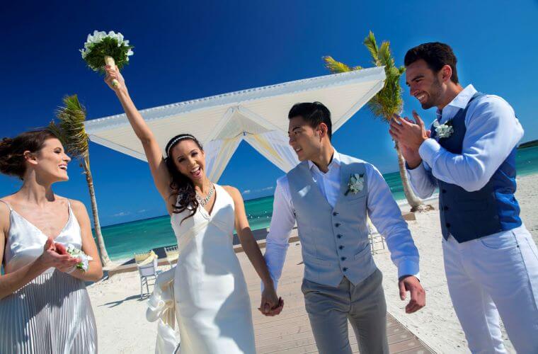  a bride and groom celebrating their wedding at a beach ceremony 