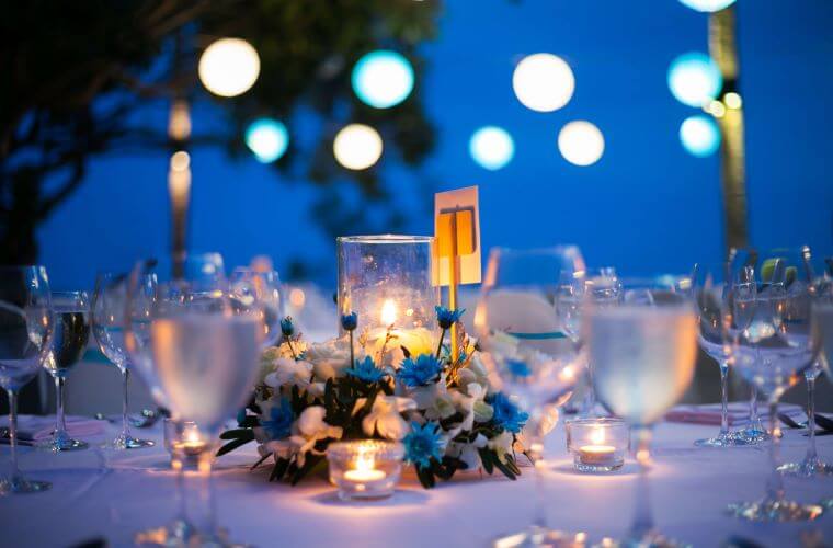glasses and candles on a table set for a wedding celebration 