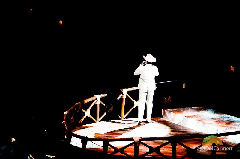 Person signing in white suit at Spectacular Mexico at Xcaret