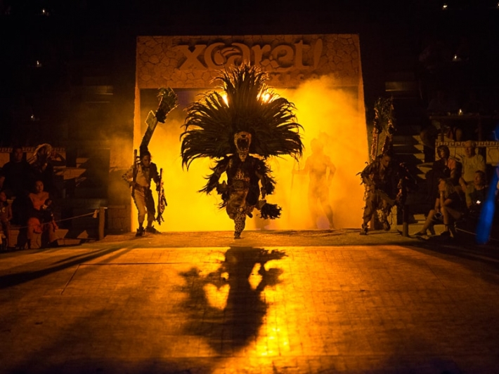 Mayan dancer emerges onto stage at the Xcaret evening program Spectacular Mexico