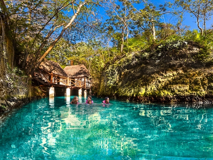 Family swimming in the floating river at Xcaret Park Mexico