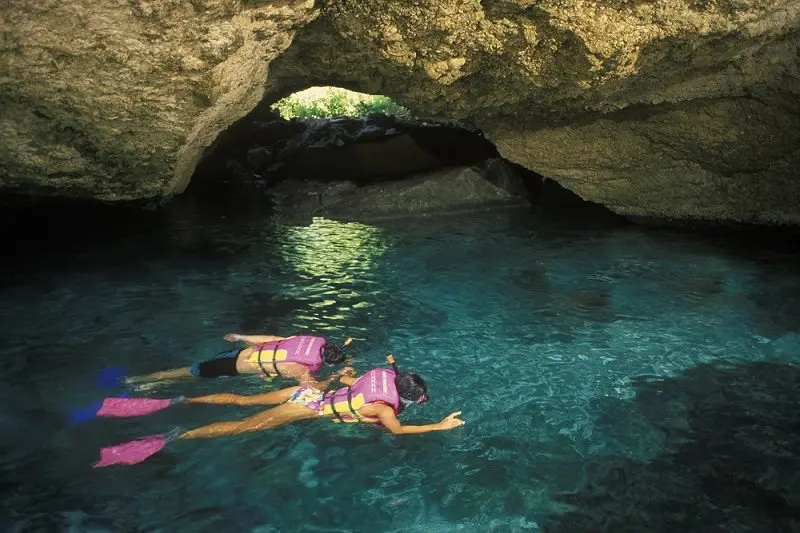 Family snorkeling at Xcaret Park in cenote