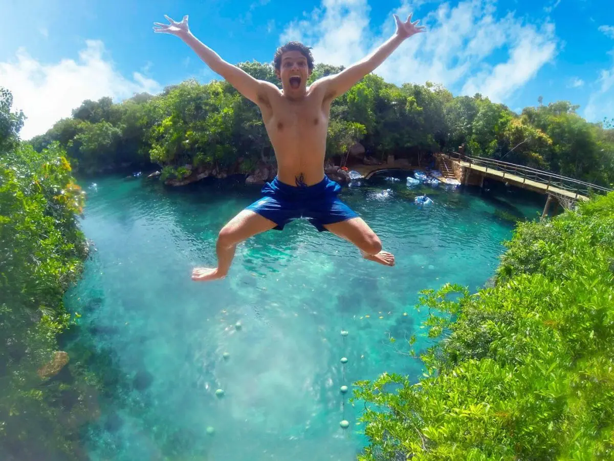 Person jumping off cliff at Xel Ha Water Park