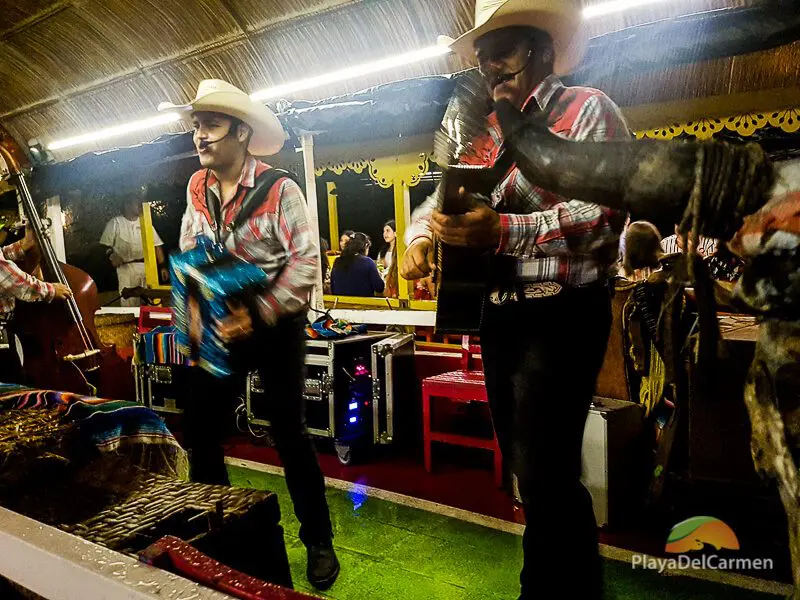 Musicians perform norteño music on the Xoximilco Dinner Cruise