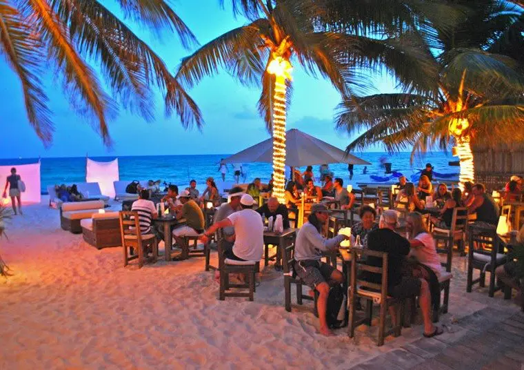 Guests listen to live music at Zenzi Beach Bar in Playa del Carmen